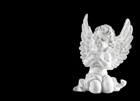 Little white guardian angel isolated on black background. Christmas decorationの写真素材