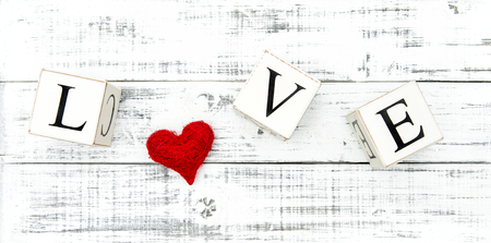 Letter LOVE and red heart on rustic wooden background. Valentines day conceptの写真素材