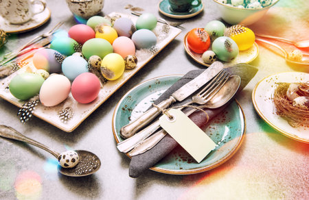 Easter decoration colorful eggs and green plants. Vintage style toned picture