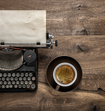 Antique typewriter with grungy textured paper page and coffeeの写真素材