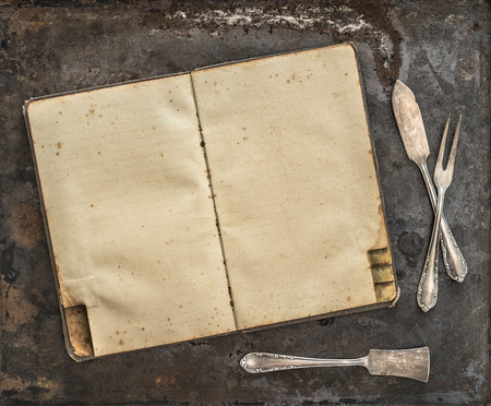 Vintage recipe book. Antique silverware on rustic metal backgroundの写真素材