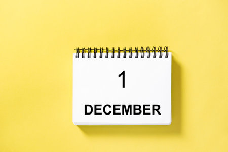 Calendar book for date on yellow background. 1 december