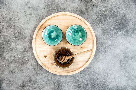 Kitchen utensils. Colorful plates and wooden board on stone backgroundの写真素材