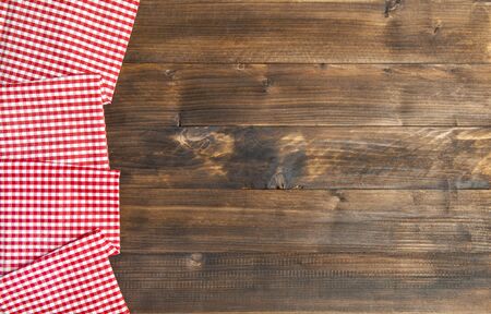 Wooden kitchen table background and chequered tableclothの写真素材
