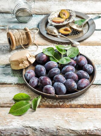 Plum fruits on rustic wooden background. Jam marmalade preparingの写真素材