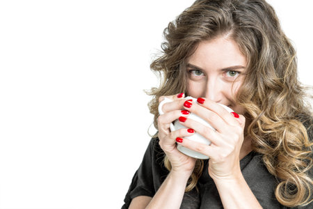 Lovely girl with cup of coffee. Young woman enjoying hot drink