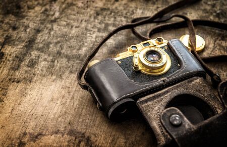 Old vintage film photo camera. Vintage style toned pictureの写真素材