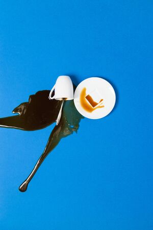 Spilled coffee on classic blue background. Minimal conceptの写真素材