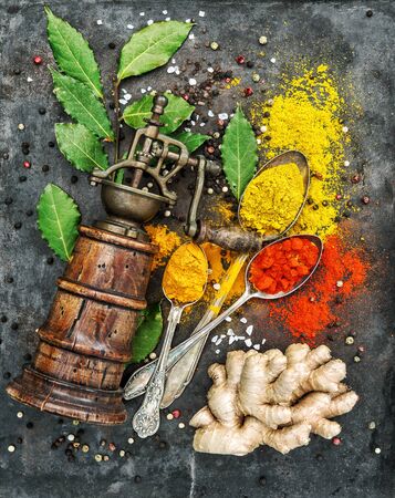 Food background. Spices and old pepper mill. Curry, turmeric, ginger, bay leaf, paprika powderの写真素材