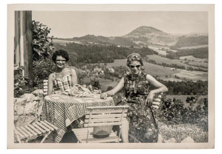 Old photo of young fashion women outdoors. Vintage picture with original film grain and blur from ca.1960のeditorial素材