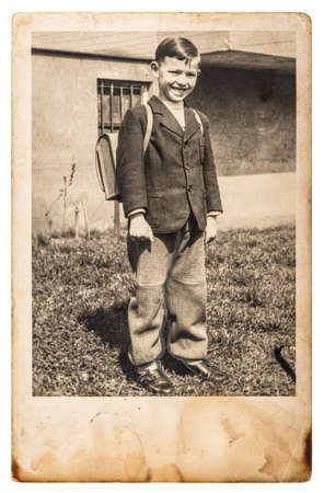Vintage photo of school boy. Retro picture with original film grain, blur and scratchesのeditorial素材