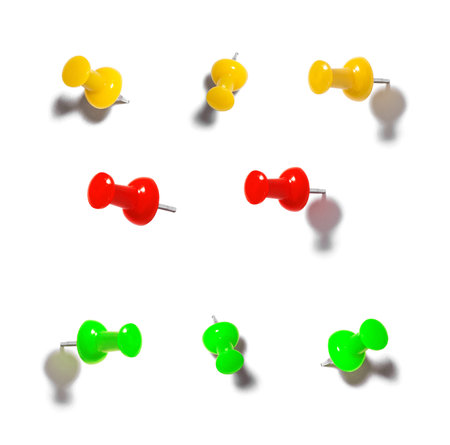 Push pin close-up on white background. Yellow red green pushpin