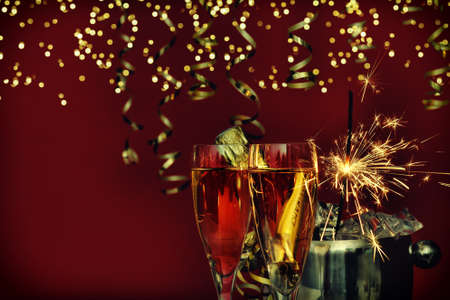 Glasses, bottle of champagne, sparklers and golden lights. happy New Yearの写真素材