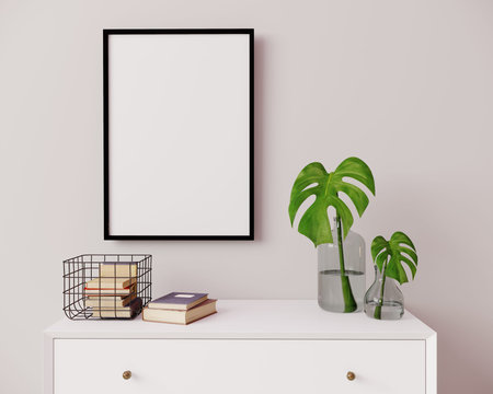 Vertical frame mockup in modern interior background. Empty frame above white chest of drawers with...