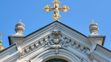 a church building adorned with golden crosses and symbols atop its roof, set against a backdrop of clear blue sky, radiating a sense of spiritual reverence and divine serenityの素材