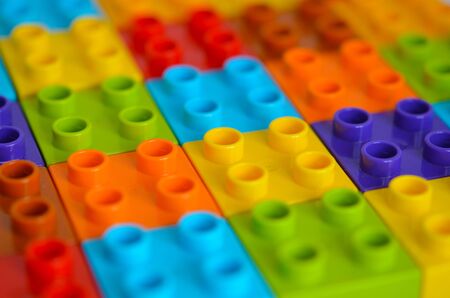 Colored toy bricks. Randomly laid out plastic building blocks. Background. Children game.の写真素材