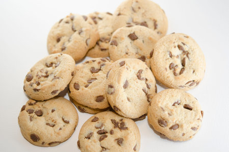 Close up on cookies with dark chocolate chips on the white background. Dessert and pastries