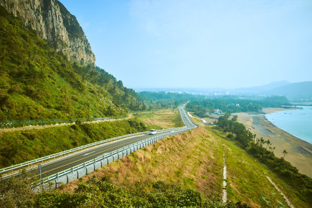 road running through the mountains and the sea