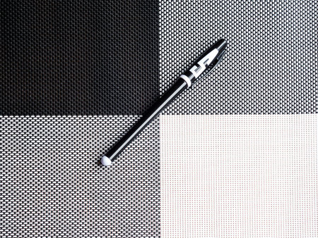 Black-white pen on the black-white wicker backgroundの写真素材