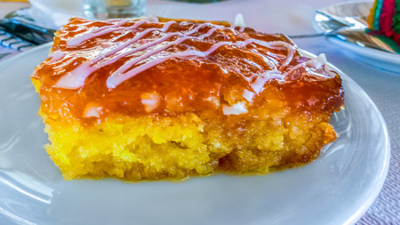 Piece of orange cake on a white plate. Close upの写真素材