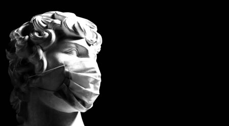 coronavirus. young man in a medical mask - place for text. sculpture in a protective mask is a contemporary art. Kovid-19 in Europe. medical mask - disease preventionの写真素材