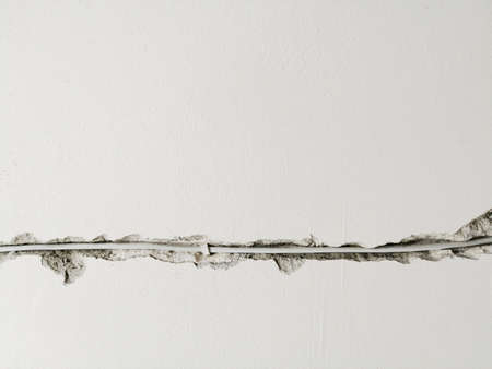 Socket and electrical wires on the wall, home renovation conceptの写真素材