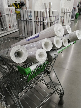 wallpaper rolls in supermarket trolley for renovationの写真素材