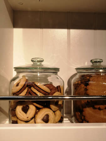 cookies in a glass jar on a shelf. baking in the kitchenの写真素材