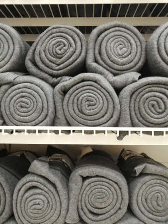 blanket plaid on the shelf in the store. home test paper in rolls of gray colorの写真素材