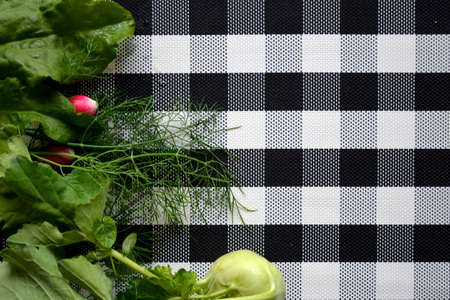 Vegetables are on the cutting Board. ingredients for vitamin salad on a checkered background.の写真素材