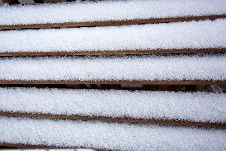 Iron poles were covered with snow. Winter has begun. Freshly fallen snow at an industrial enterprise. Slippery steps in the snowの写真素材