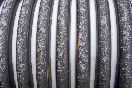 The barrel was covered with snow. Beginning of winter. Freshly fallen snow at an industrial...