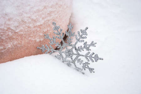 Snowflake in the snow. Christmas snow background with pumpkin. Christmas background with empty field for text.の写真素材