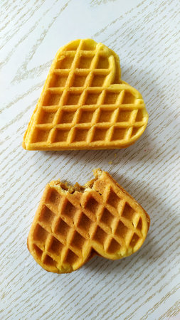 Two hearts Cookies. We bit off a cookie. Dessert on a wooden background. Homemade cakes for...