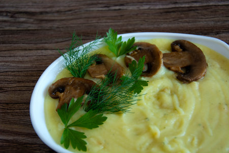 Mashed potatoes. A garnish of champignon mushrooms with mashed potatoes are in a white heart-shaped...
