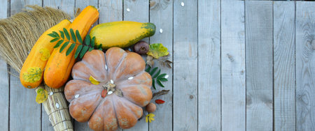 Pumpkin and zucchini on a wooden background with an empty field for text. Festive autumn decor for...
