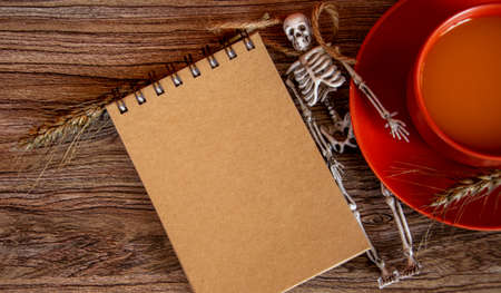 Halloween card with skeleton and notepad. Autumn background.の写真素材