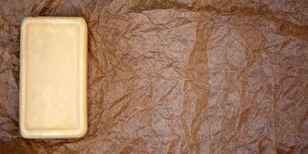 A bar of soap on craft paper.の写真素材