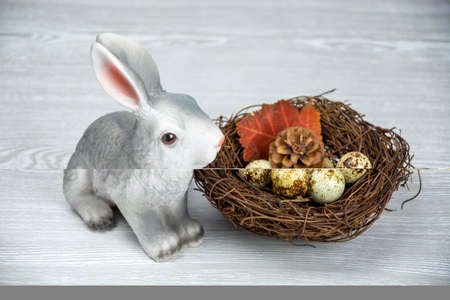 Easter Bunny and Easter eggs in the nest. Spring composition on a light background.の写真素材