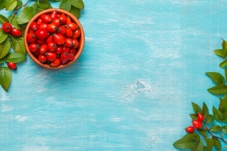 Cup with hip roses on wooden blue table. close upの写真素材