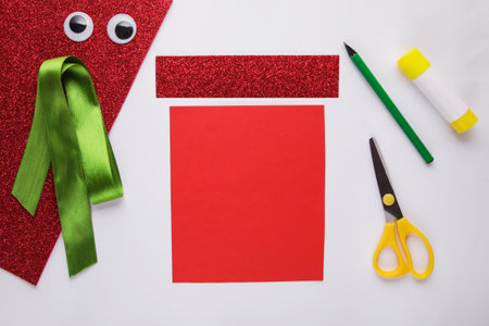 little child making christmas decoration Gift from paper. Children's art project. DIY concept....
