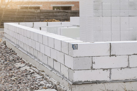 Construction of Aerated Concrete. Unfinished house wall made from white aerated autoclaved concrete blocksの写真素材