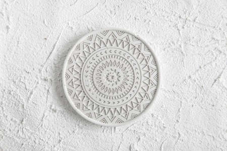 Decor Home Gypsum. Handmade Concrete. Round Coffe Coaster on Concrete background. White Plate on white background. Concrete plate mock up. Template for product placement. top view, copy space.の写真素材