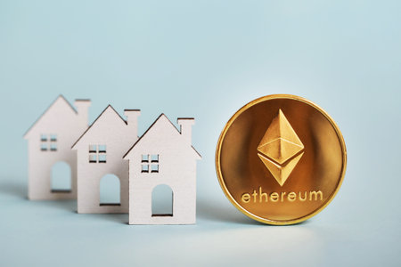 Ethereum coin, white wooden house on blue background. Tokenizing Real Estate Property concept....