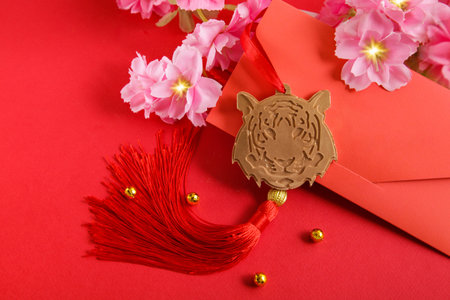 Chinese New Year 2022 decoration Gold Tiger, Red Envelope on red background. Flowers of good fortune.の写真素材