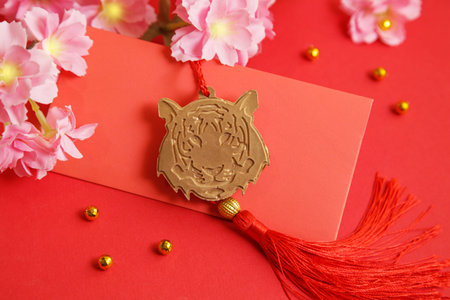 Chinese New Year 2022 decoration Gold Tiger, Red Envelope on red background. Flowers of good fortune.の写真素材