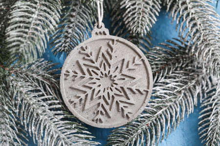 Craft Gypsum Christmas ball on christmas tree. New Years background for building store. Building Material Used in Construction. Cement, gypsum plaster.の写真素材