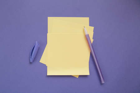 Yellow empty sheet, note paper on violet background. Copy space. Top view. Trendy color of yearの写真素材