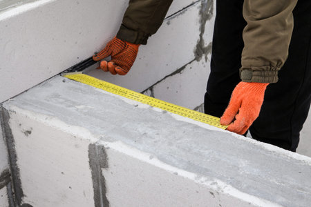 Masonry worker make concrete, check gorizontality, Construction man use Lightweight Concrete CONCRETE BLOCK for wall.の写真素材