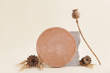 Abstract nature scene composition of stones, Dried Poppy Seed. Neutral beige background for cosmetic, identity, packaging.の写真素材